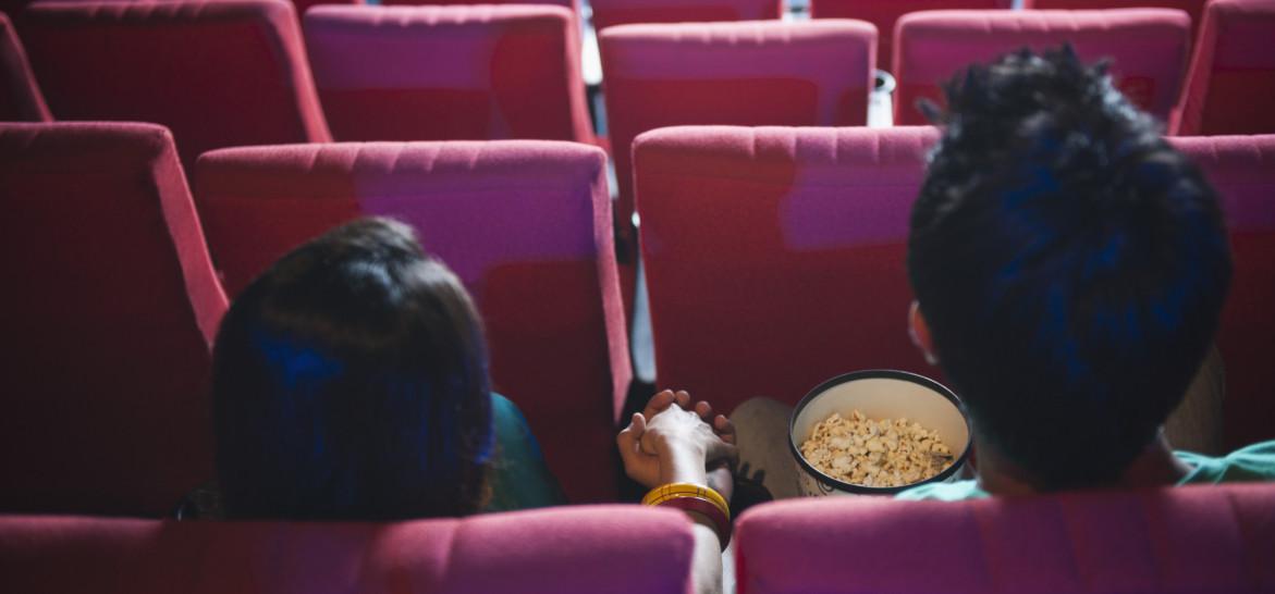 mv-a-movie-hall-theater-popcorn-couple-holding-hands